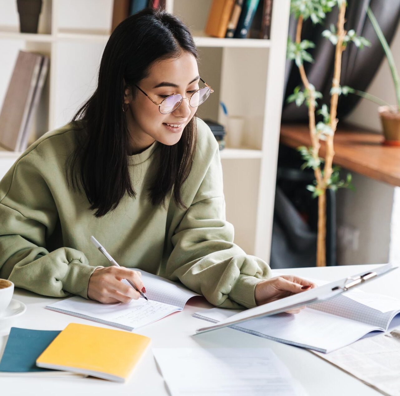 attractive-young-girl-student-studying-at-the-coll-7CLAZTG